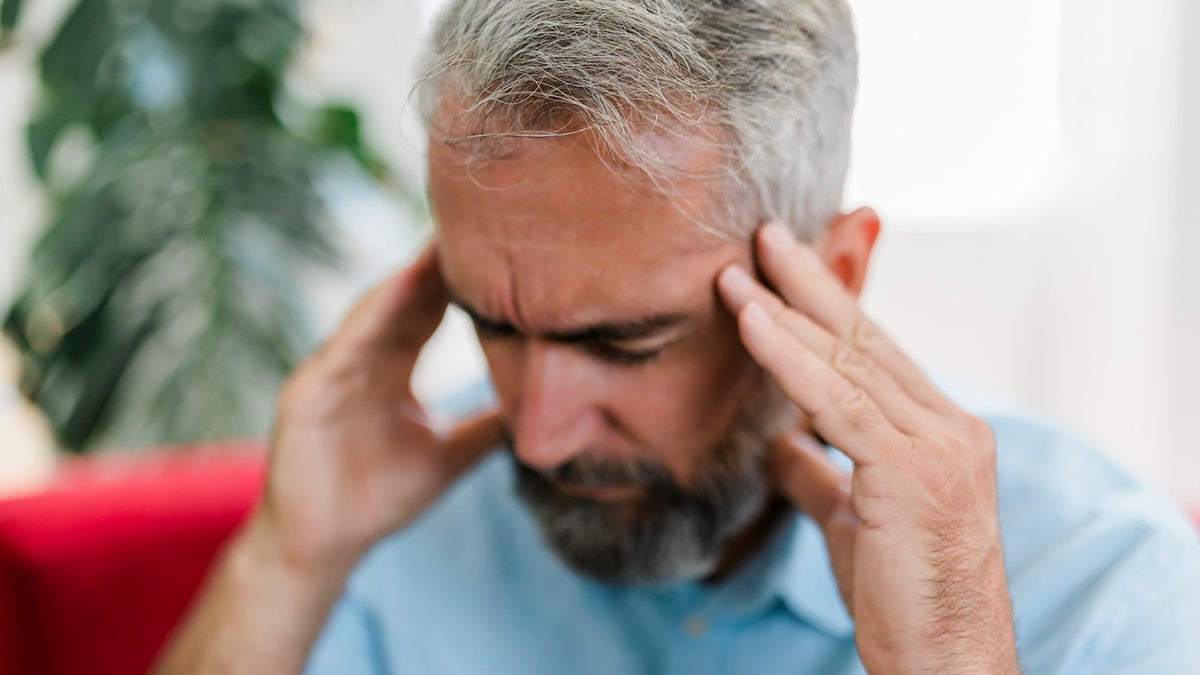 Man holding head