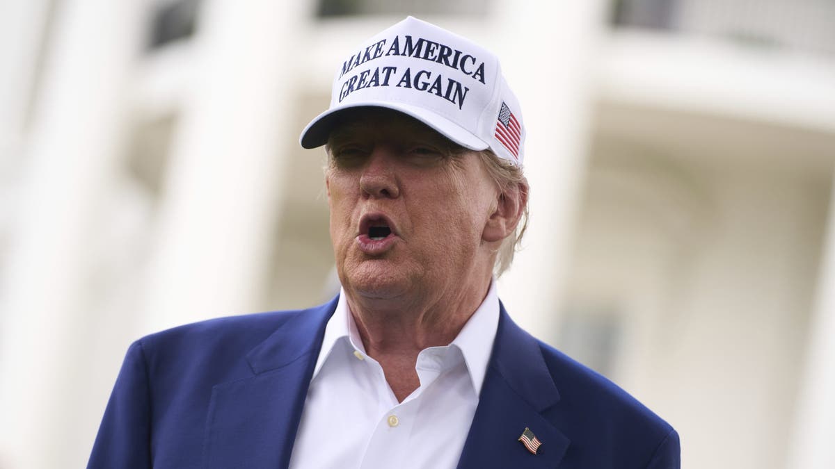 President Donald Trump talks with reporters before a flag pole is installed on the South Lawn of the White House, Wednesday, June 18, 2025, in Washington. (AP Photo/Evan Vucci)