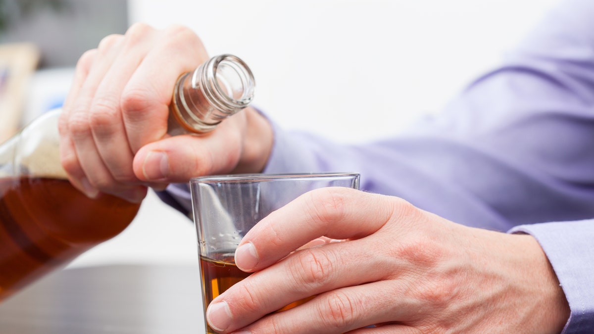 Man pouring alcohol