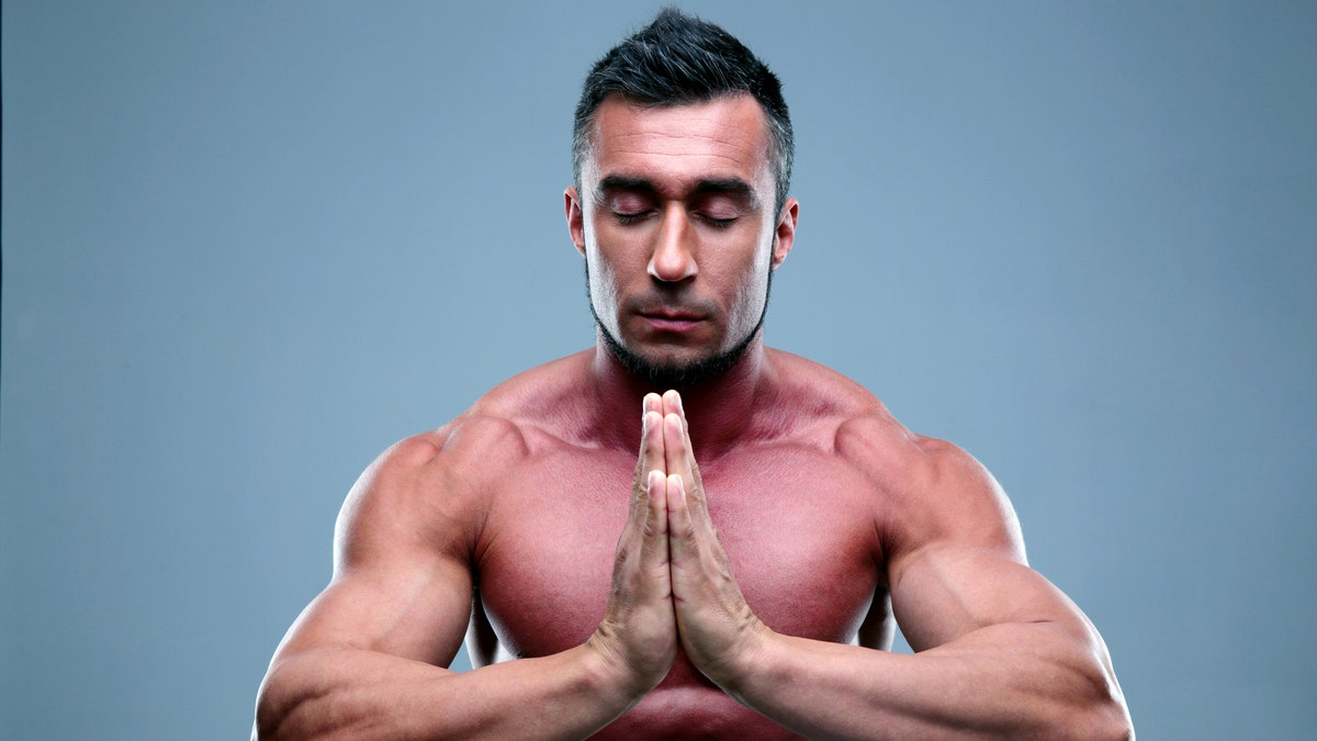 Muscular man praying