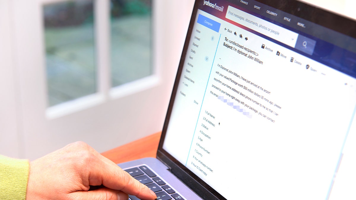 person receiving spam email on laptop