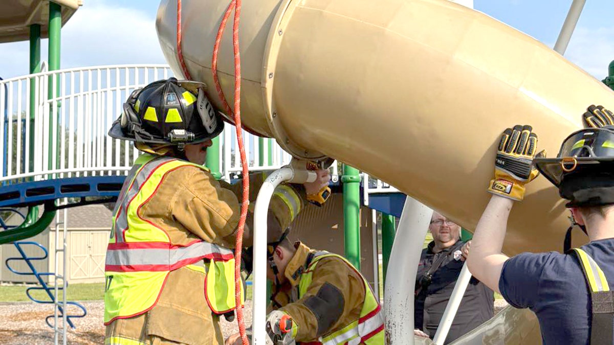firefighter slices into playground slide