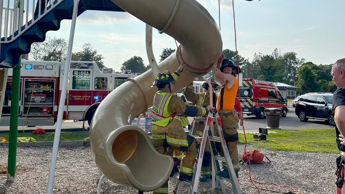 firefighters rescue man stuck in slide