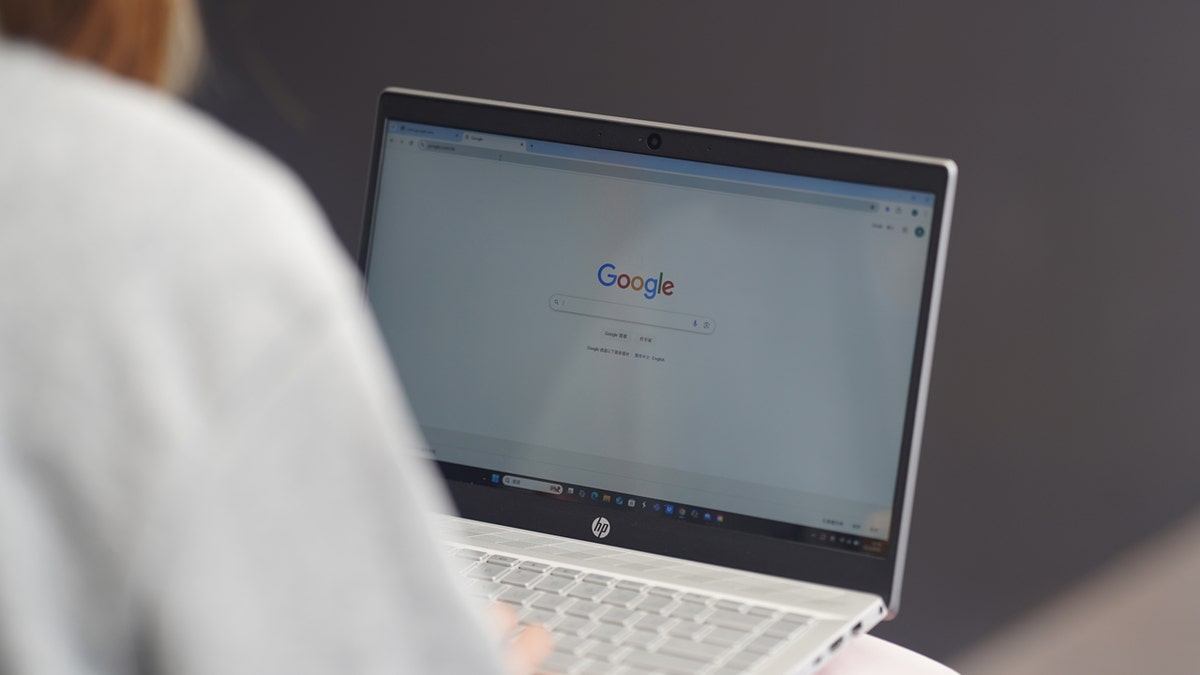 Woman conducting Google search on her laptop