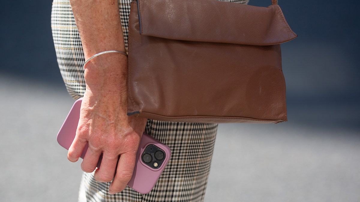 A woman holding a smartphone