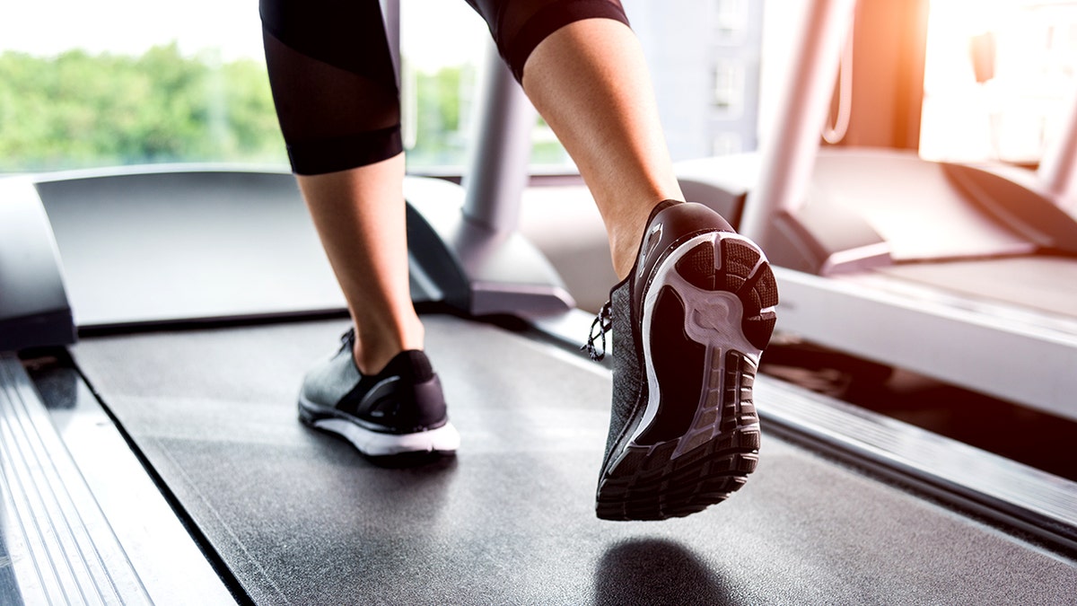 Woman running to exercise on treadmill at gym