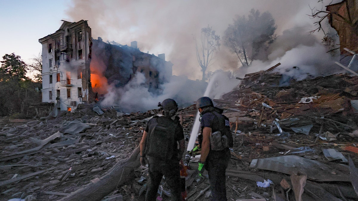 Emergency responders work to extinguish a fire after a Russian airstrike