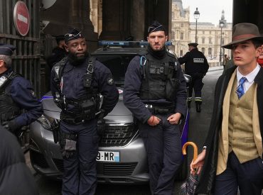 Mystery man in dapper suit goes viral after appearing in Louvre heist investigation photo