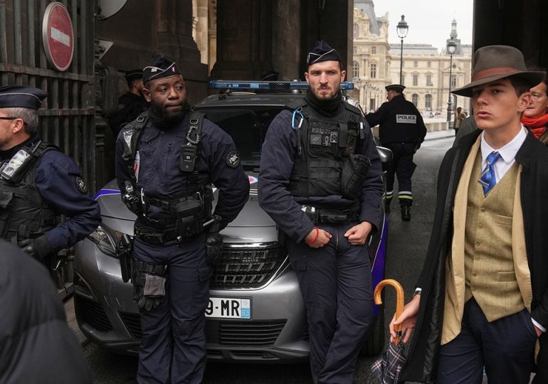 Mystery man in dapper suit goes viral after appearing in Louvre heist investigation photo