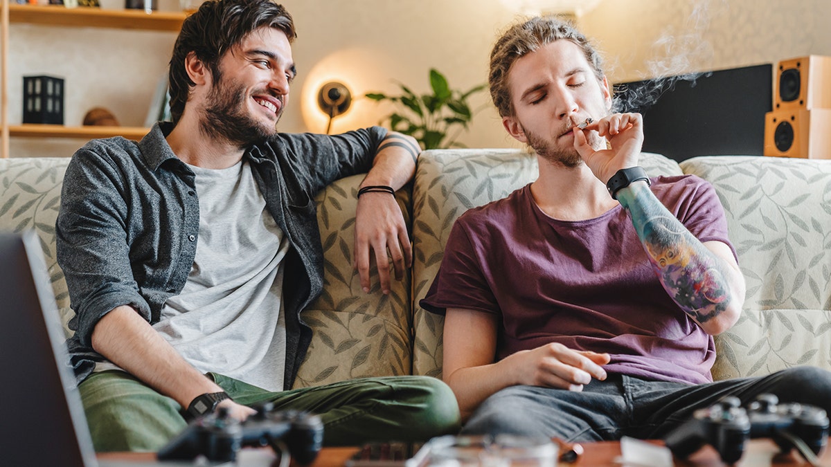 men play video games and smoke weed