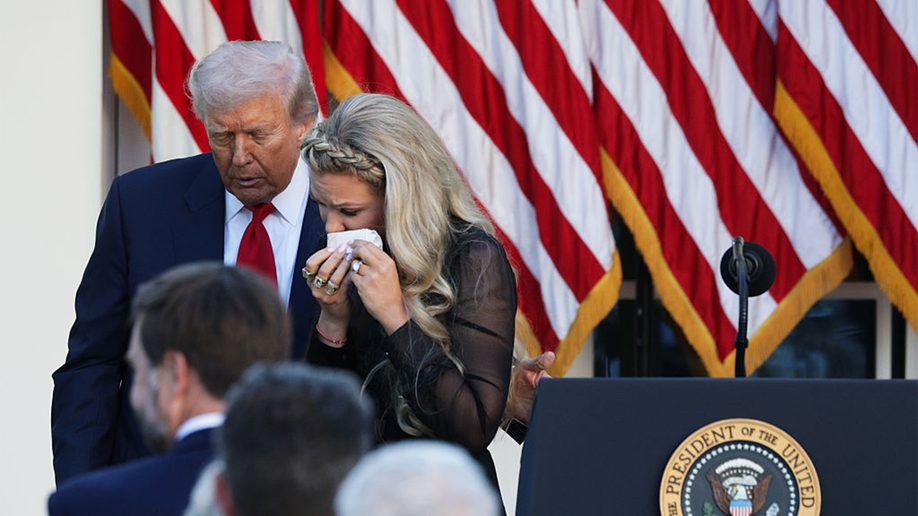 Erika Kirk walks with President Donald Trump