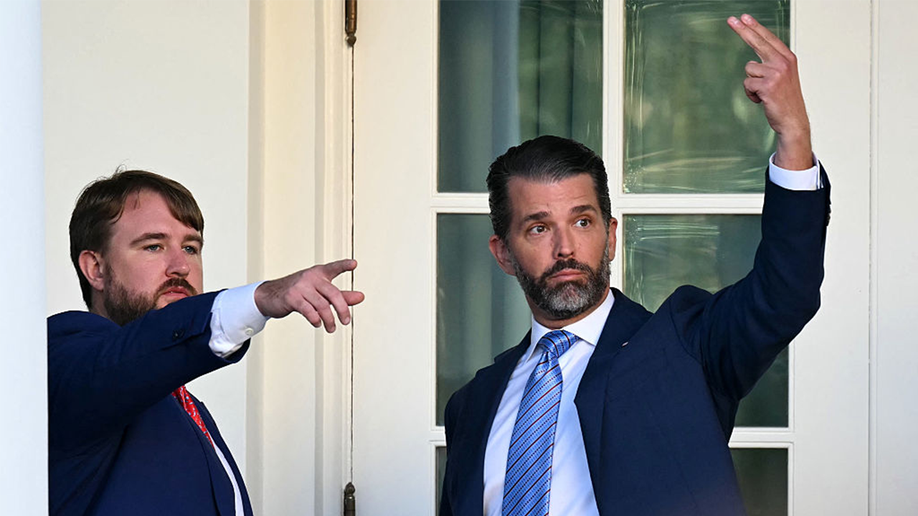 Donald Trump Jr. gestures after Charlie Kirk ceremony.