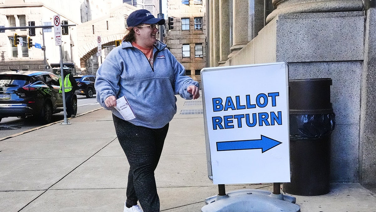 A voter drops off a mail-in ballot at the City-County Building in downtown Pittsburgh Tuesday, Nov. 4, 2025.
