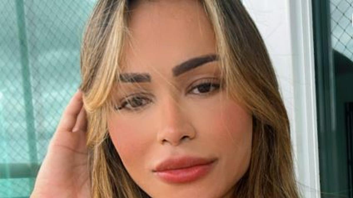 Diana Areas taking a selfie in a red outfit