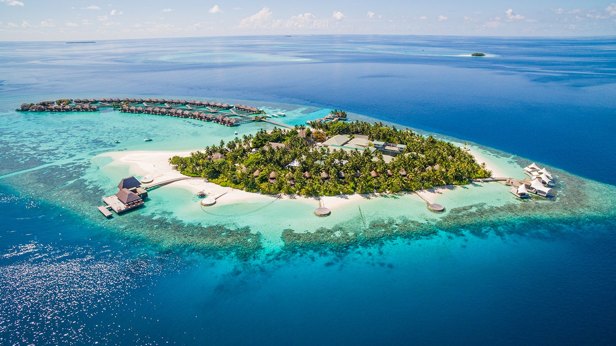 Aerial shot of the Maldives, island surrounded by ocean