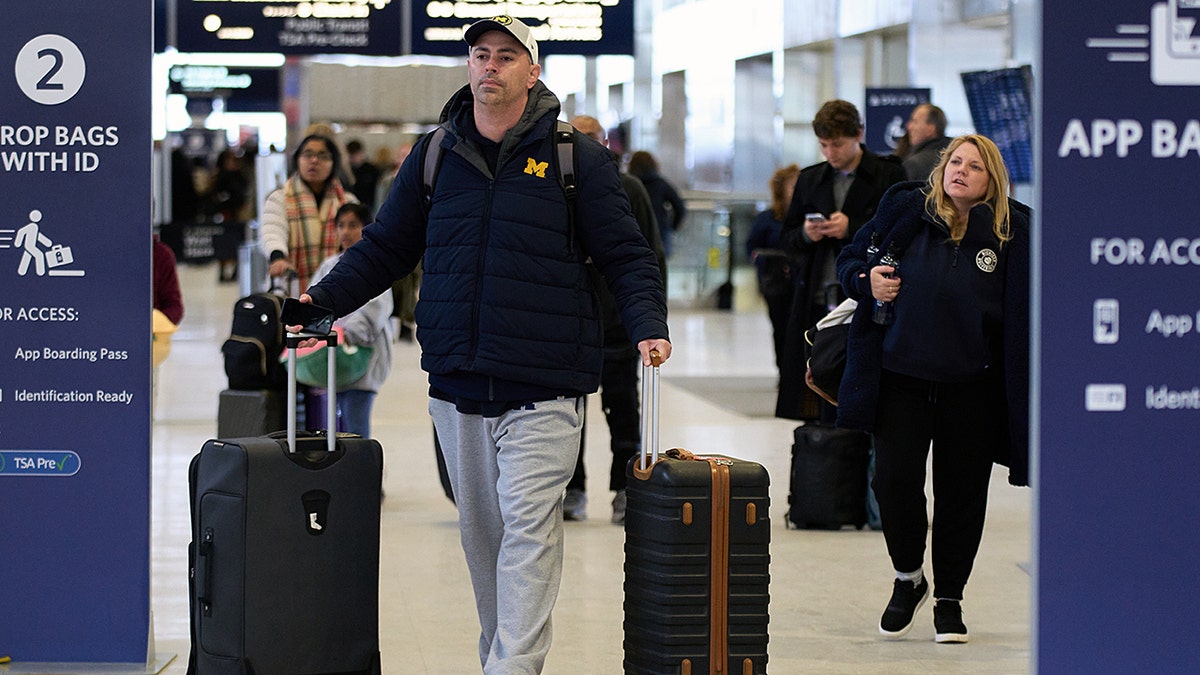 A man with suitcases at the airport