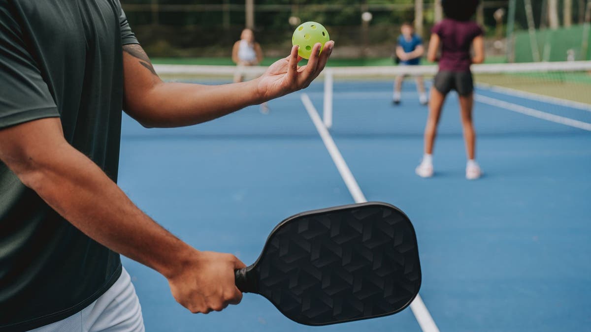 People playing pickleball on a blue court