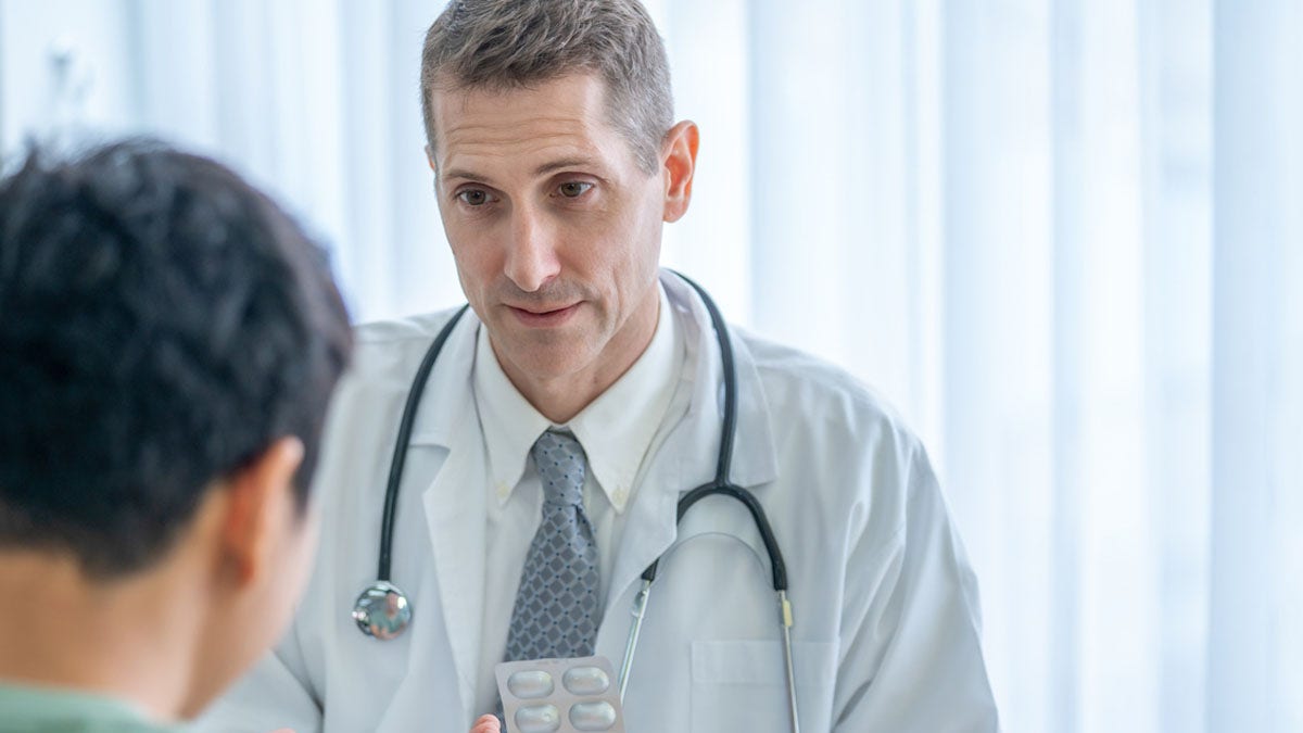 Man at doctor getting medication for diabetes