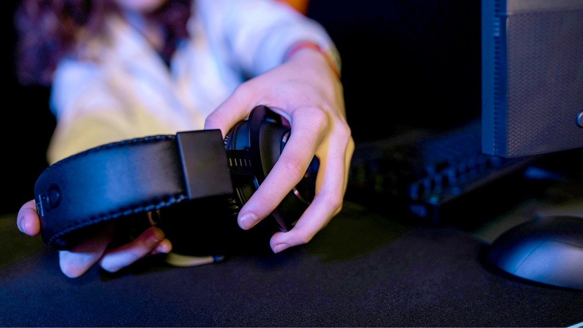 A woman holding headphones