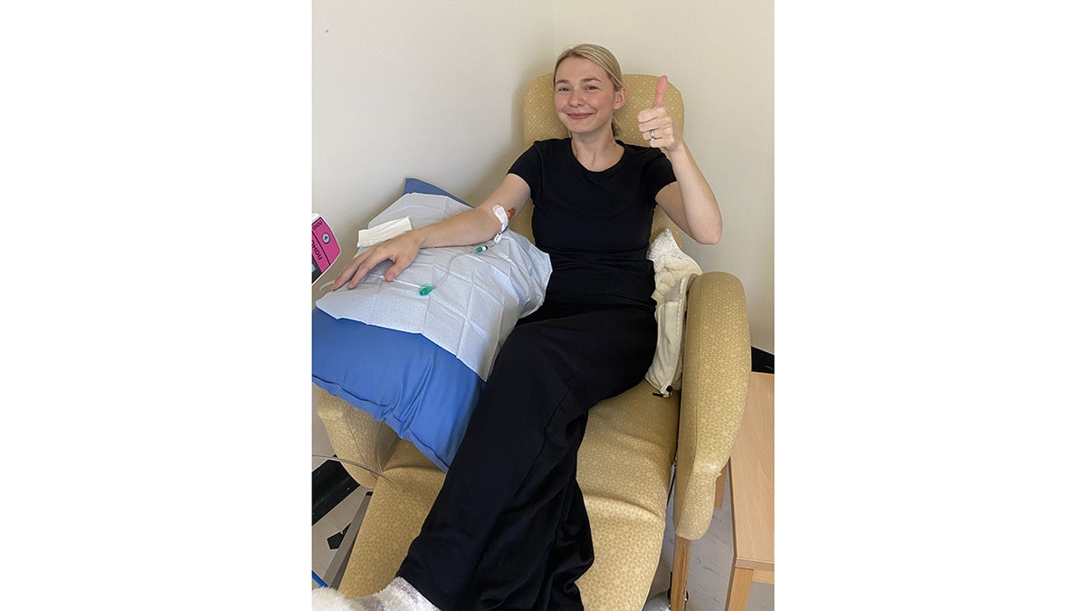 hollie thursby sits with an IV in her arm