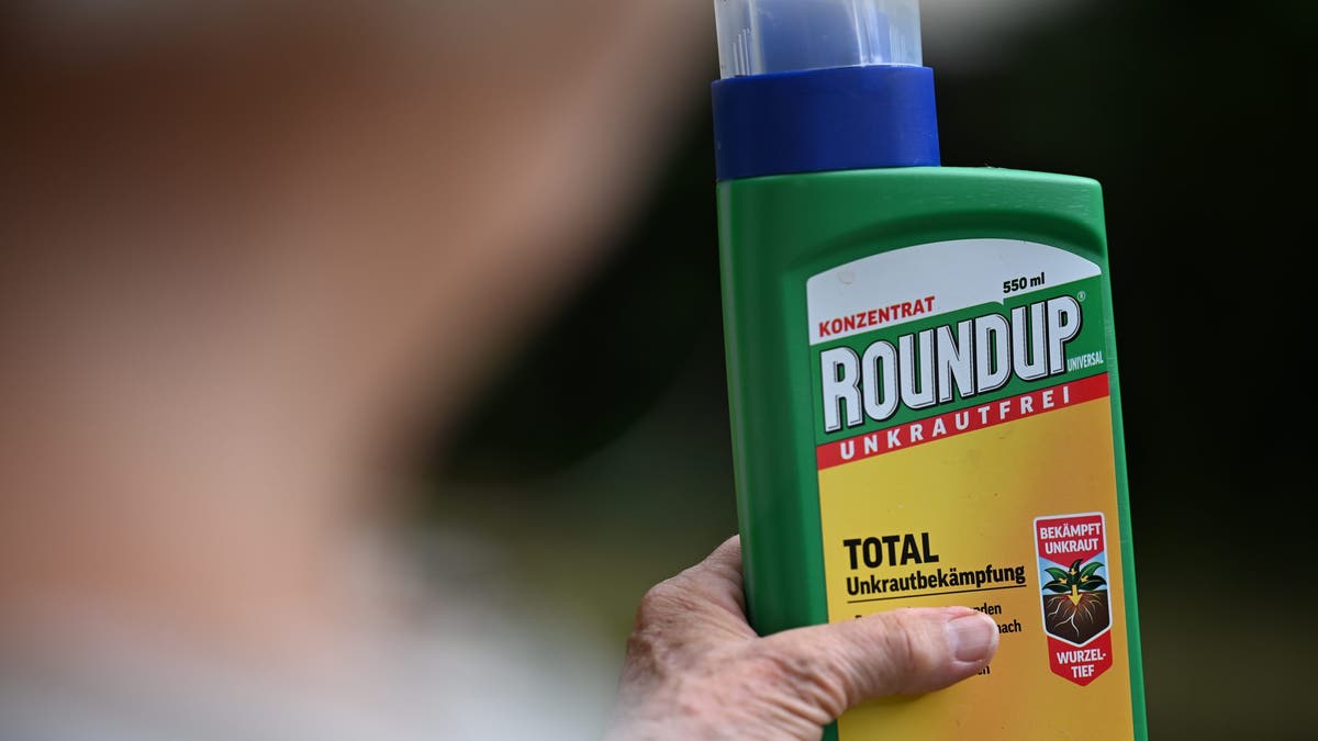 Gardener holds up pesticide