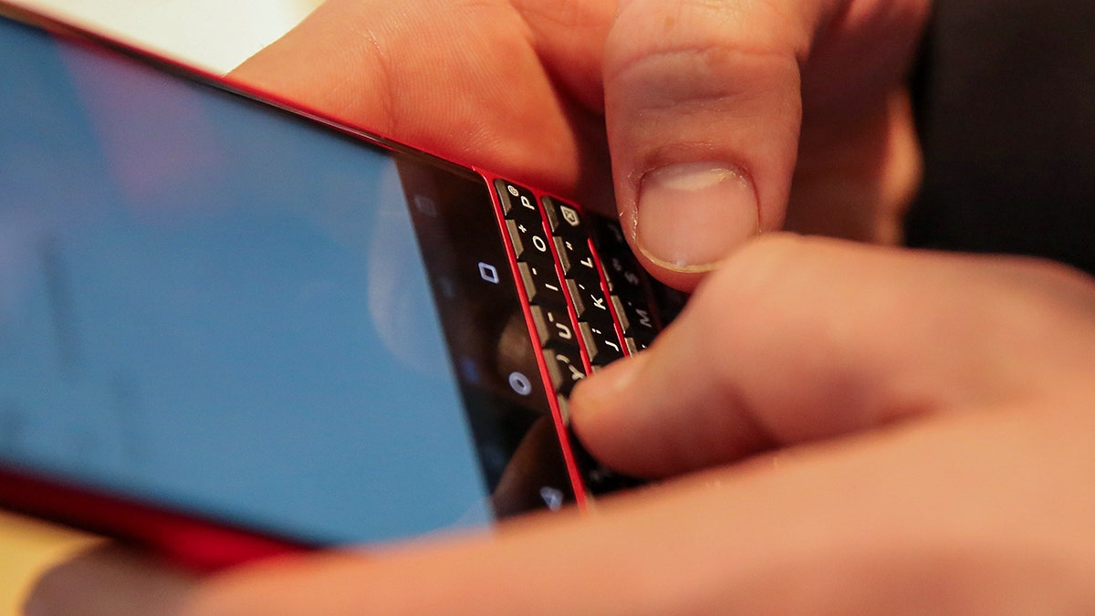 Person typing on their phone's keyboard.