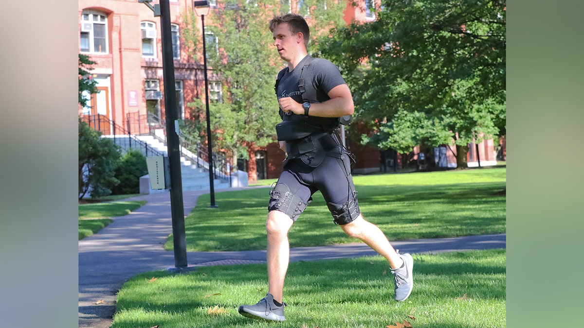 Man running at the park while wearing wearable tech.