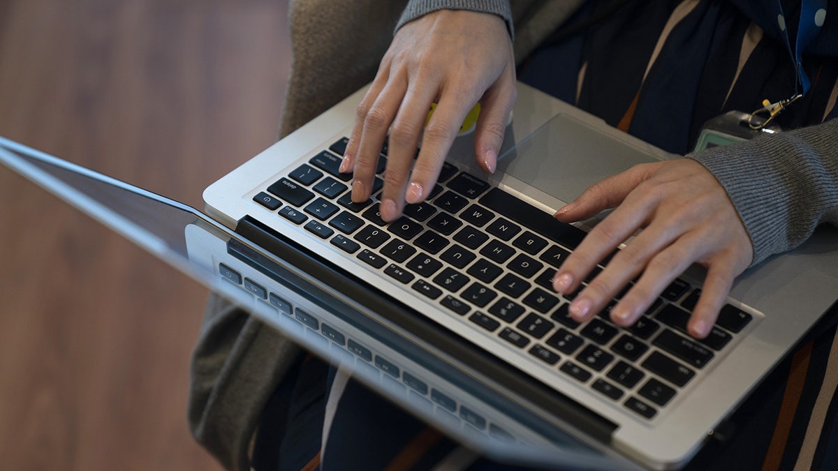 Woman typing on a computer keyboard