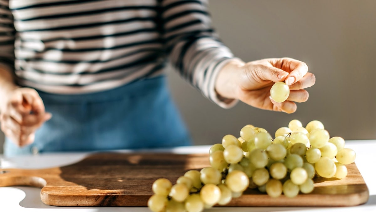 Woman eating grapes