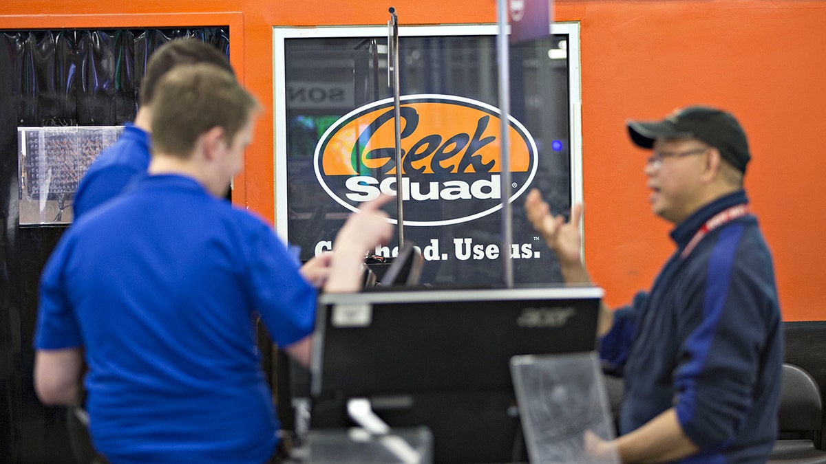 Geek Squad advertisement hanging on the wall.