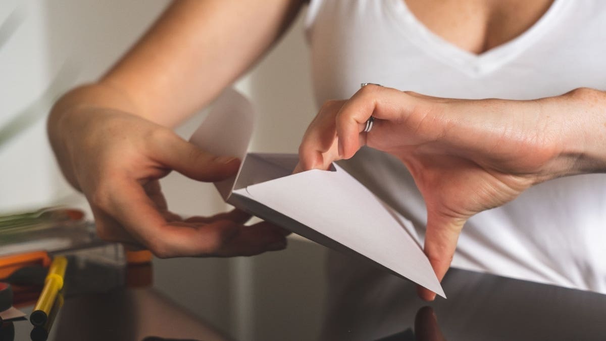 A person opening an envelope
