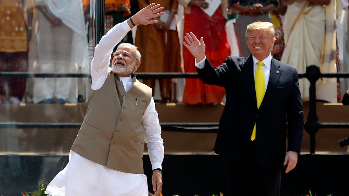 U.S. President Donald Trump and Indian Prime Minister Narendra Modi wave to the crowd at Sardar Patel Stadium in Ahmedabad, India, Monday, Feb. 24, 2020. India poured on the pageantry with a joyful, colorful welcome for President Donald Trump on Monday that kicked off a whirlwind 36-hour visit meant to reaffirm U.S.-India ties while providing enviable overseas imagery for a president in a re-election year. (AP Photo/Aijaz Rahi)