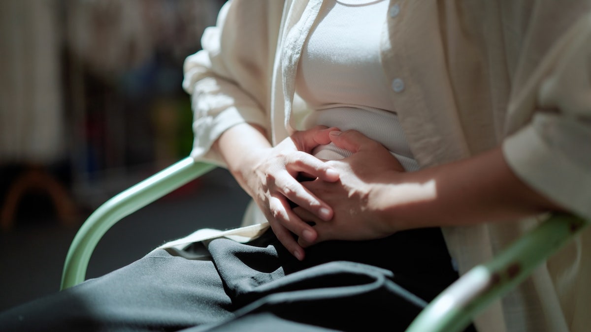 Woman holding stomach