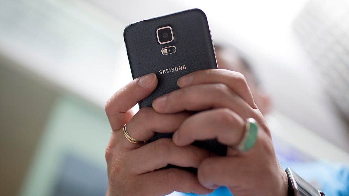 Woman typing on her Samsung smartphone.