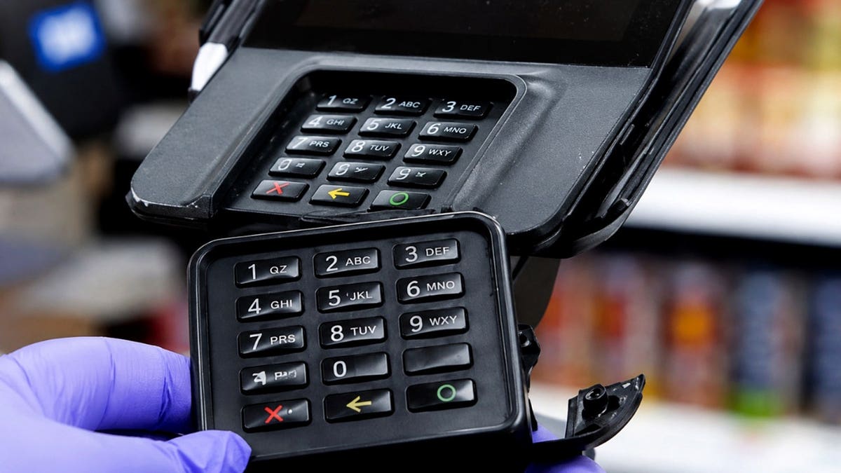 A card skimming machine is shown over a card reader.