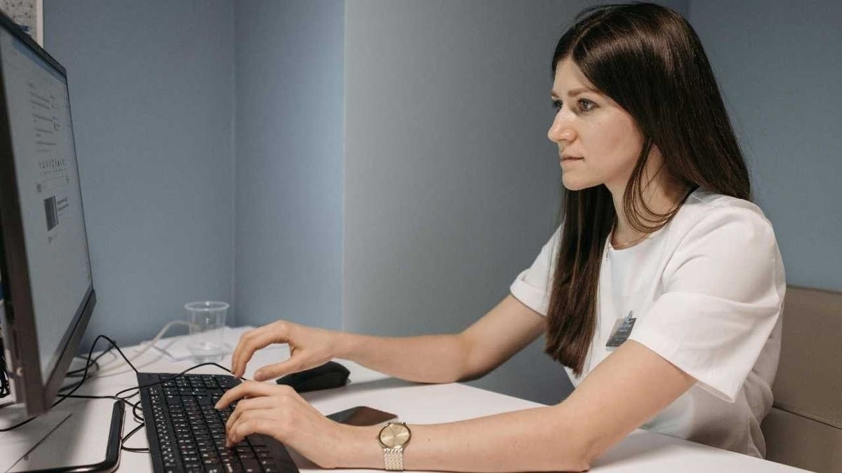Woman typing on her laptop.