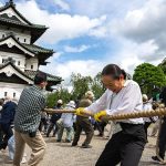 Hundreds of volunteers pull 360-tonne historic Japanese castle back into place by hand