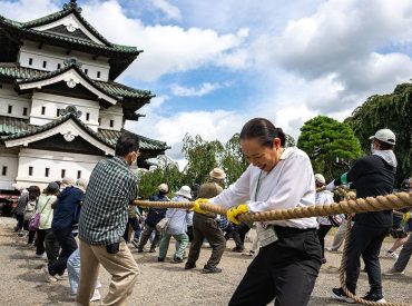 Hundreds of volunteers pull 360-tonne historic Japanese castle back into place by hand