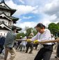Hundreds of volunteers pull 360-tonne historic Japanese castle back into place by hand
