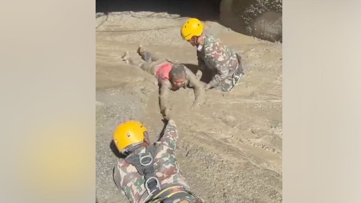 Trapped Nepali workers pulled from hydropower tunnel after catastrophic flooding