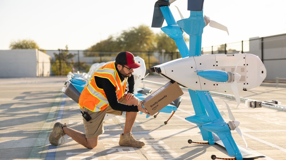 Workers setting up an Amazon drone.