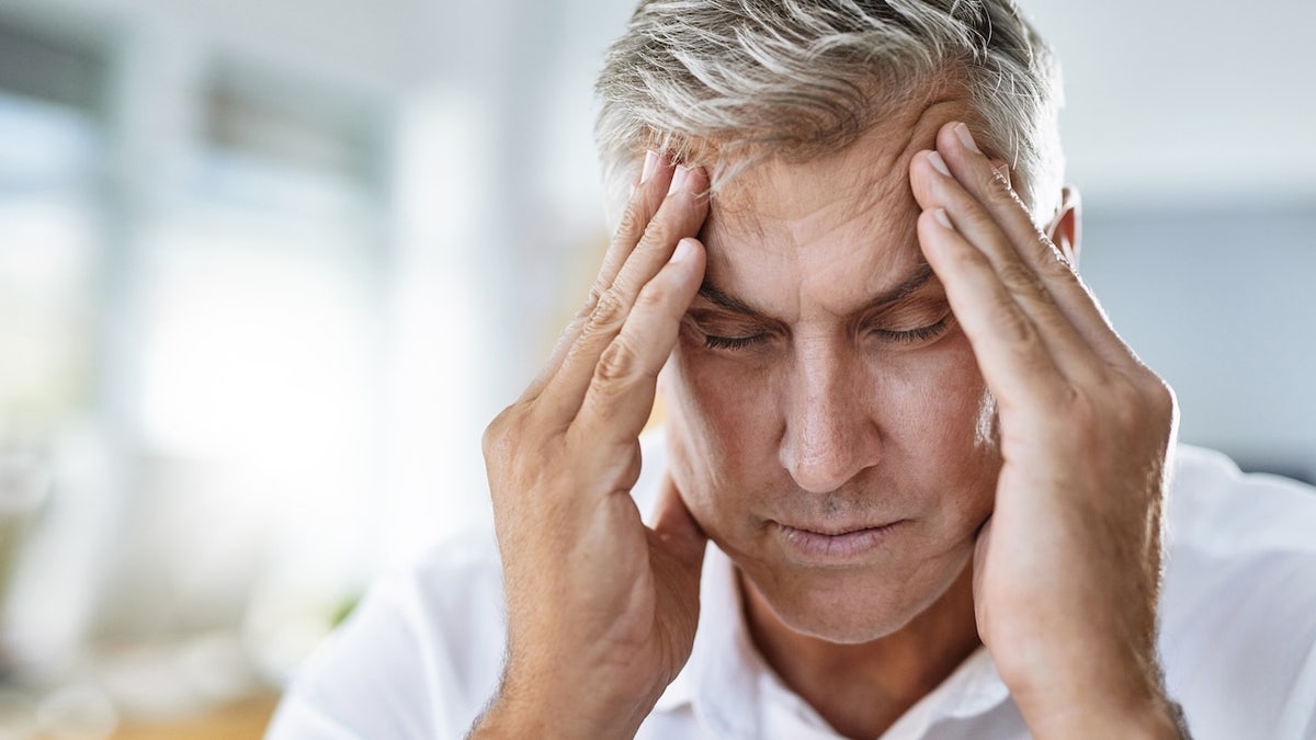 Man holding head
