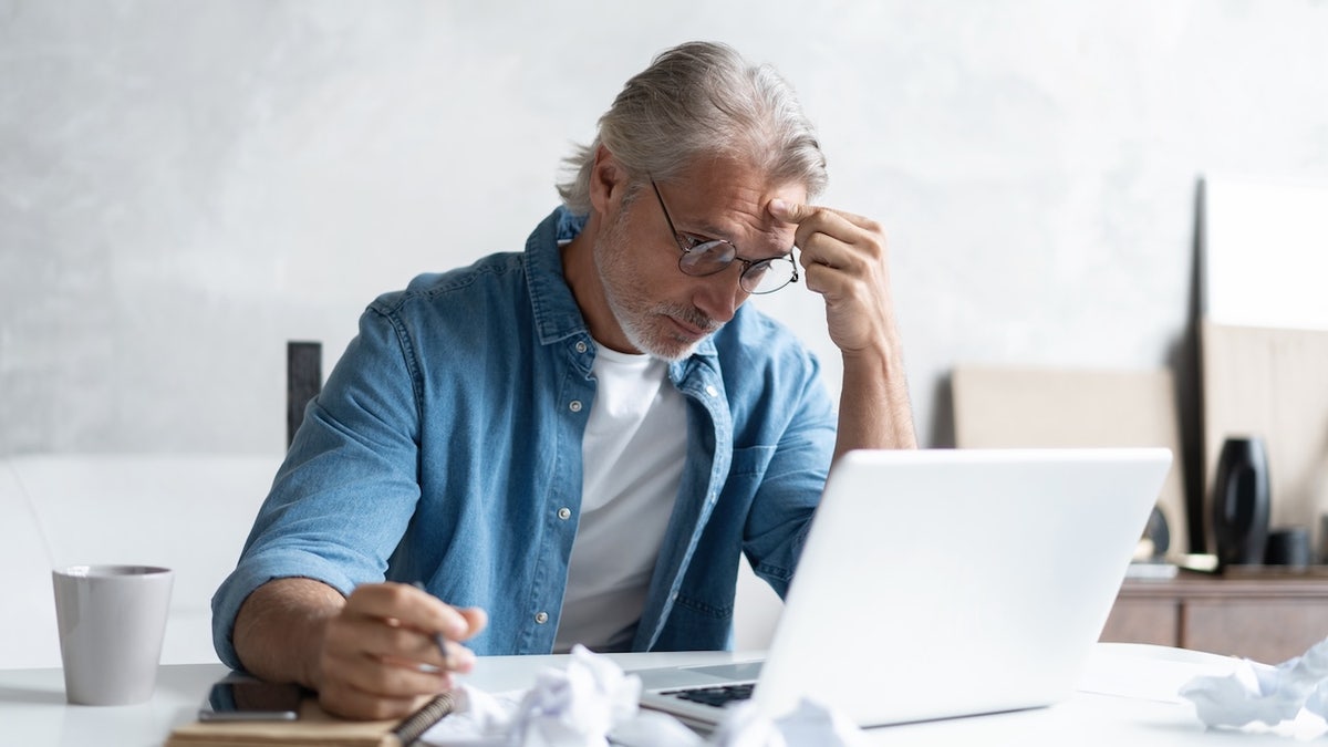 Man overwhelmed at computer