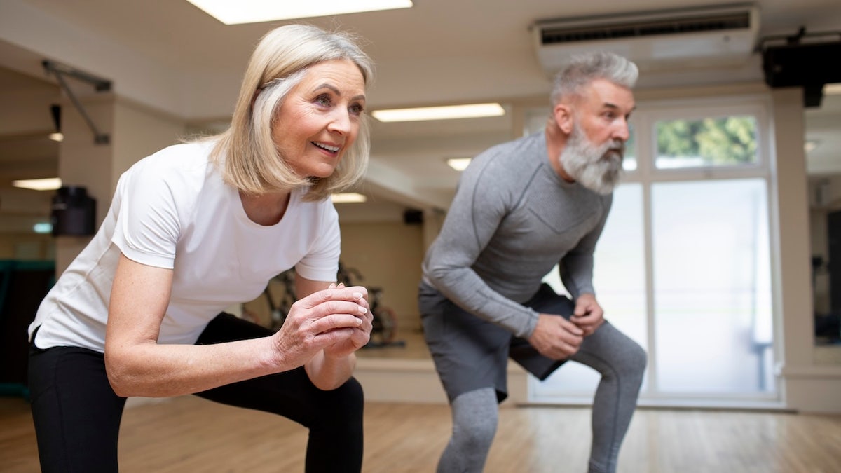 Mature heterosexual couple using a health studio to stay fit and to keep active.
