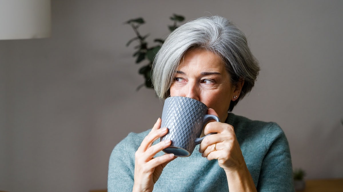 Older woman drinking from mug