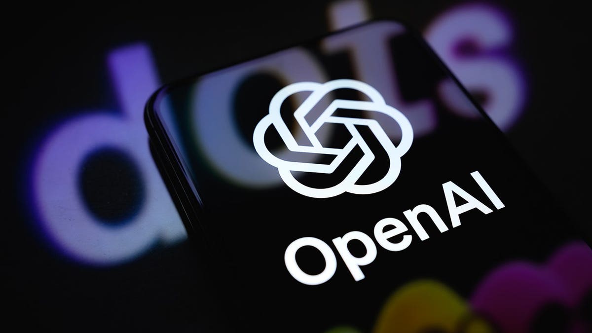 OpenAI logo displayed on a smartphone screen with Dots promotional artwork projected onto a reflective surface.